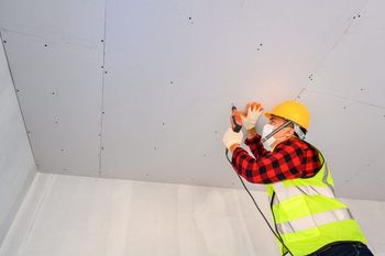 man-reparing-ceiling