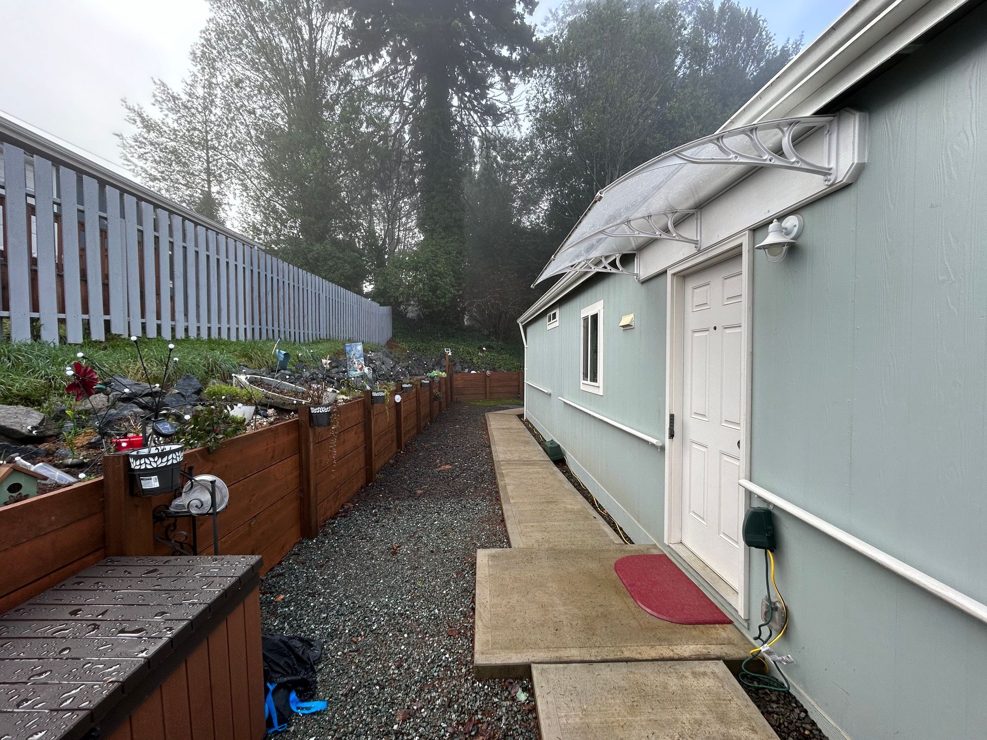 A house with a fence and a walkway leading to it