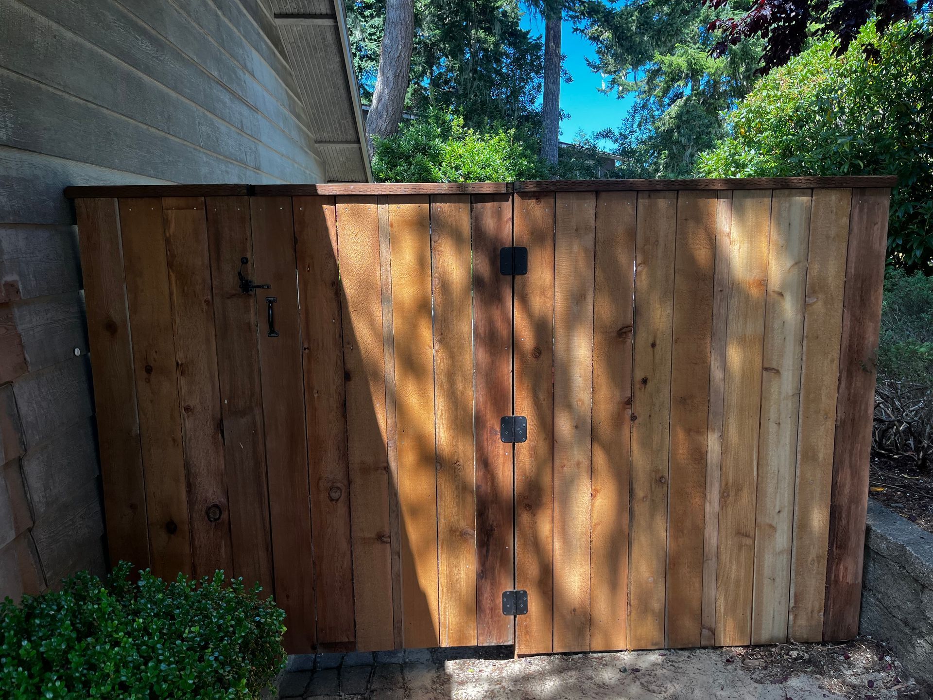A wooden fence is sitting in front of a house.
