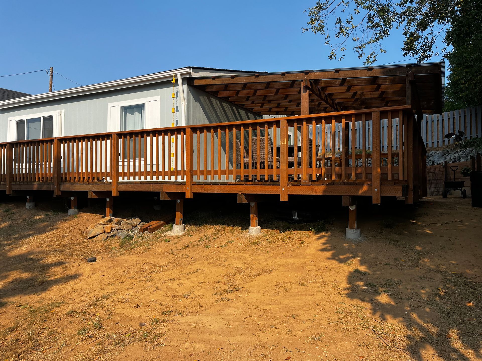 A house with a large wooden deck in front of it