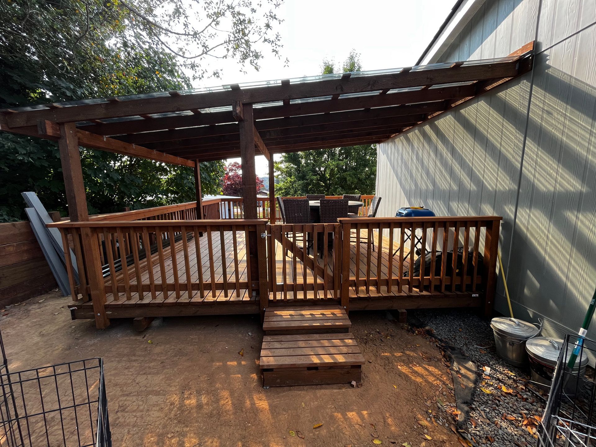 A wooden deck with a pergola on top of it