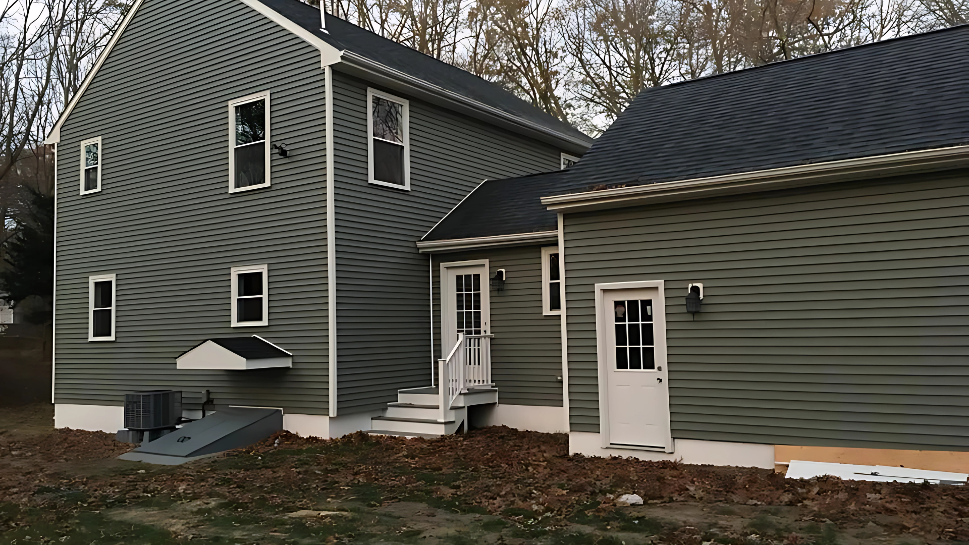 A room under construction with a ladder and a stool on the floor.