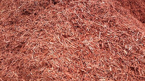 Reddish-brown wood mulch, shredded and piled.