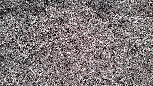 Pile of dark brown shredded mulch.