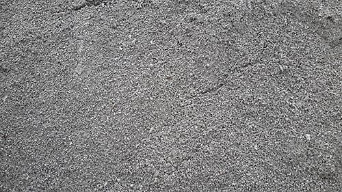 Close-up of a pile of small, dark gray gravel.
