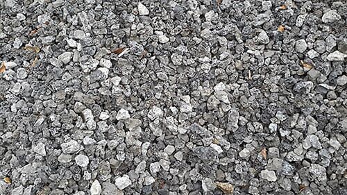 Crushed stone gravel in various shades of gray, filling the frame.