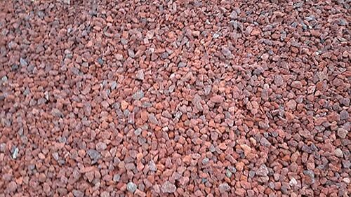 Red gravel, small and irregularly shaped, covers the ground.