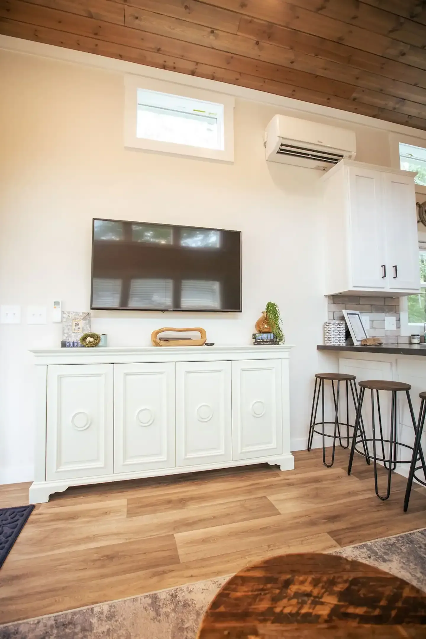 A living room with a flat screen tv on the wall.