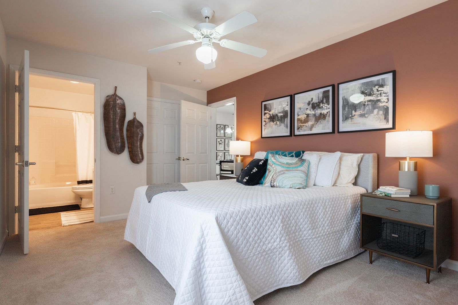 A bedroom with a large bed and a ceiling fan.