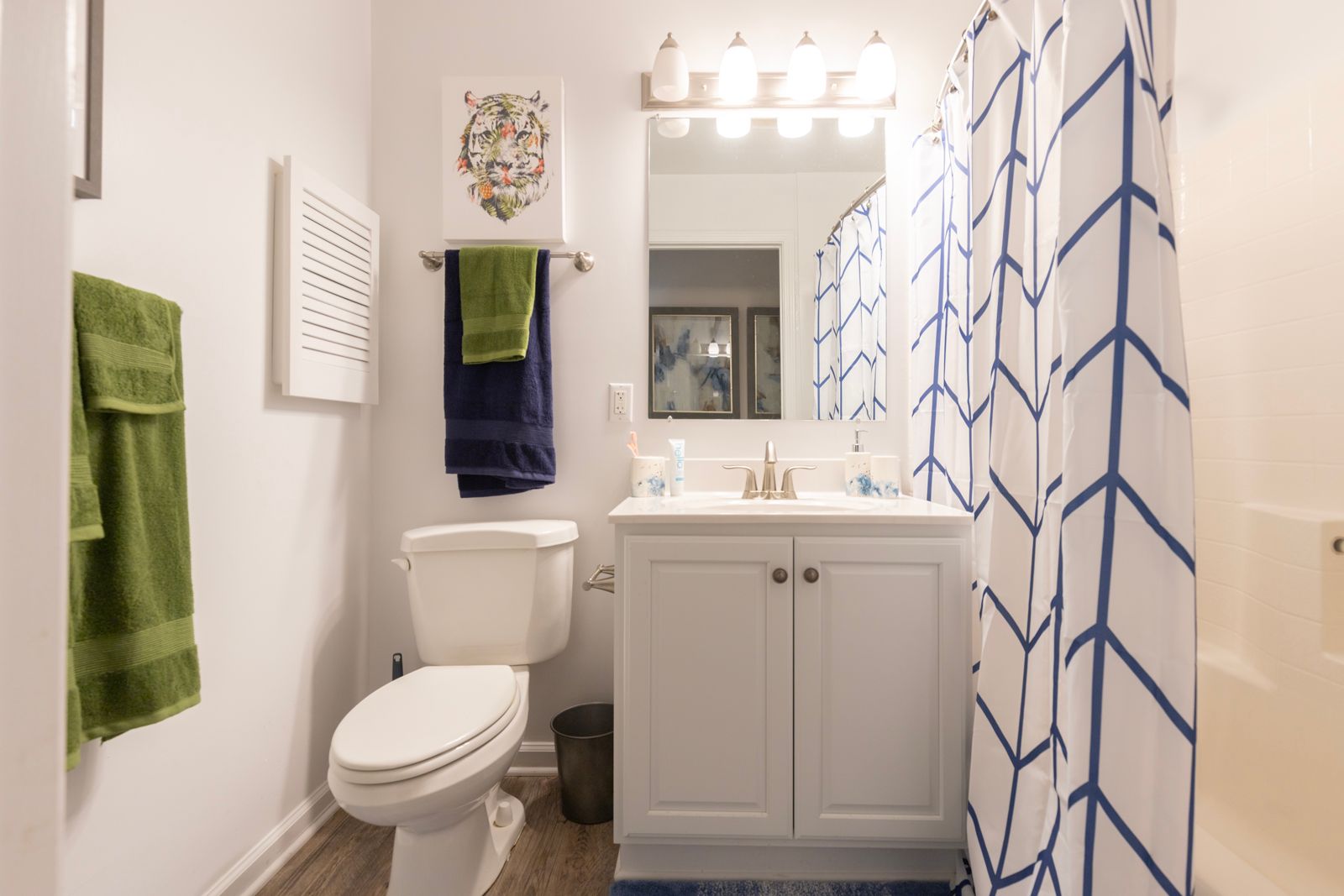 A bathroom with a toilet , sink , and shower curtain.