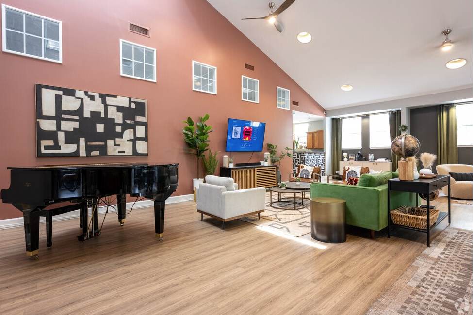 Living room: grand piano, abstract art, green sofa, TV, modern décor.