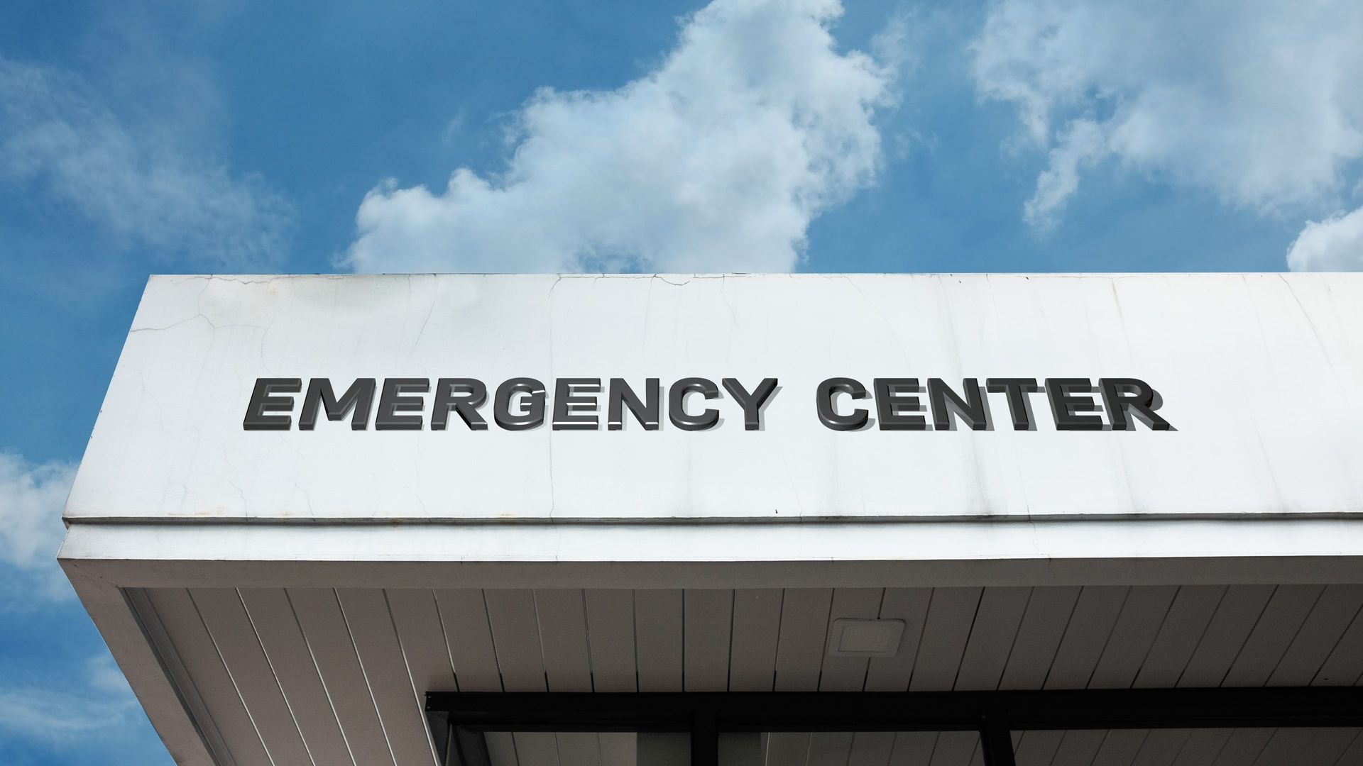 A security guard is holding a flashlight in front of a staircase.