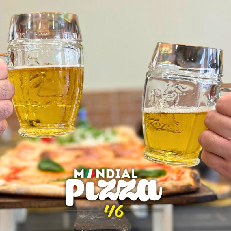 Due persone brindano con dei bicchieri di birra davanti a una pizza, con il logo 