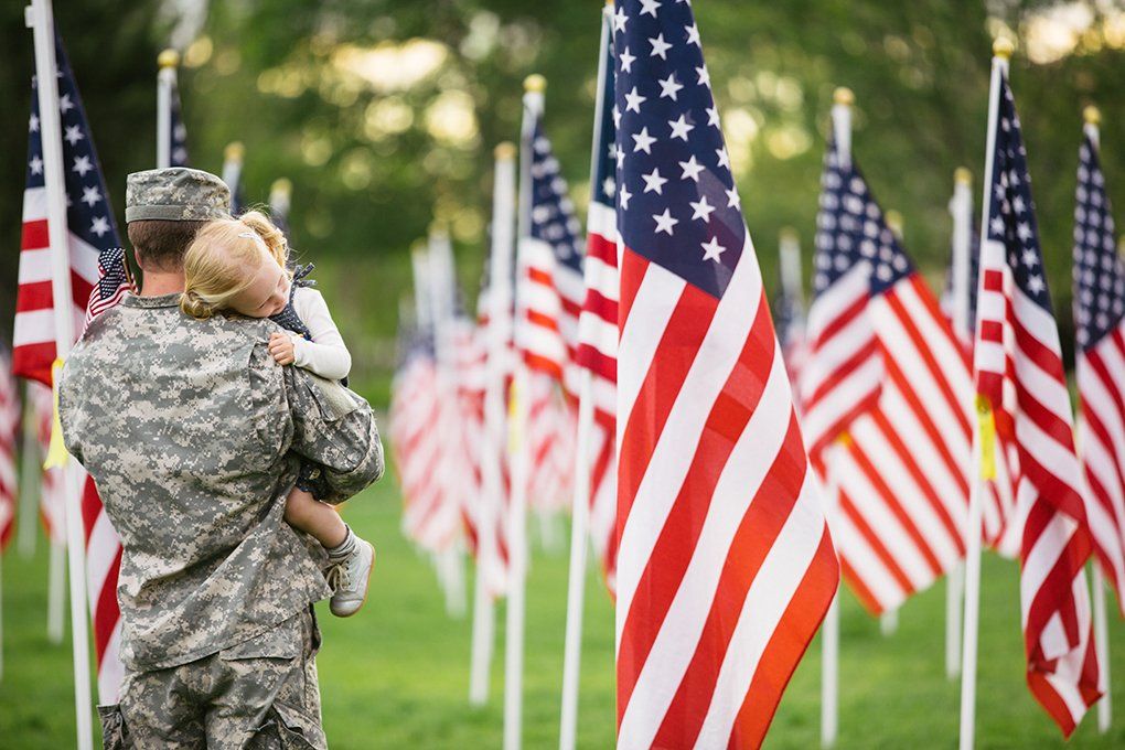 Veteran holding infant daughter - FairHaven 5% Prearrangement Offer