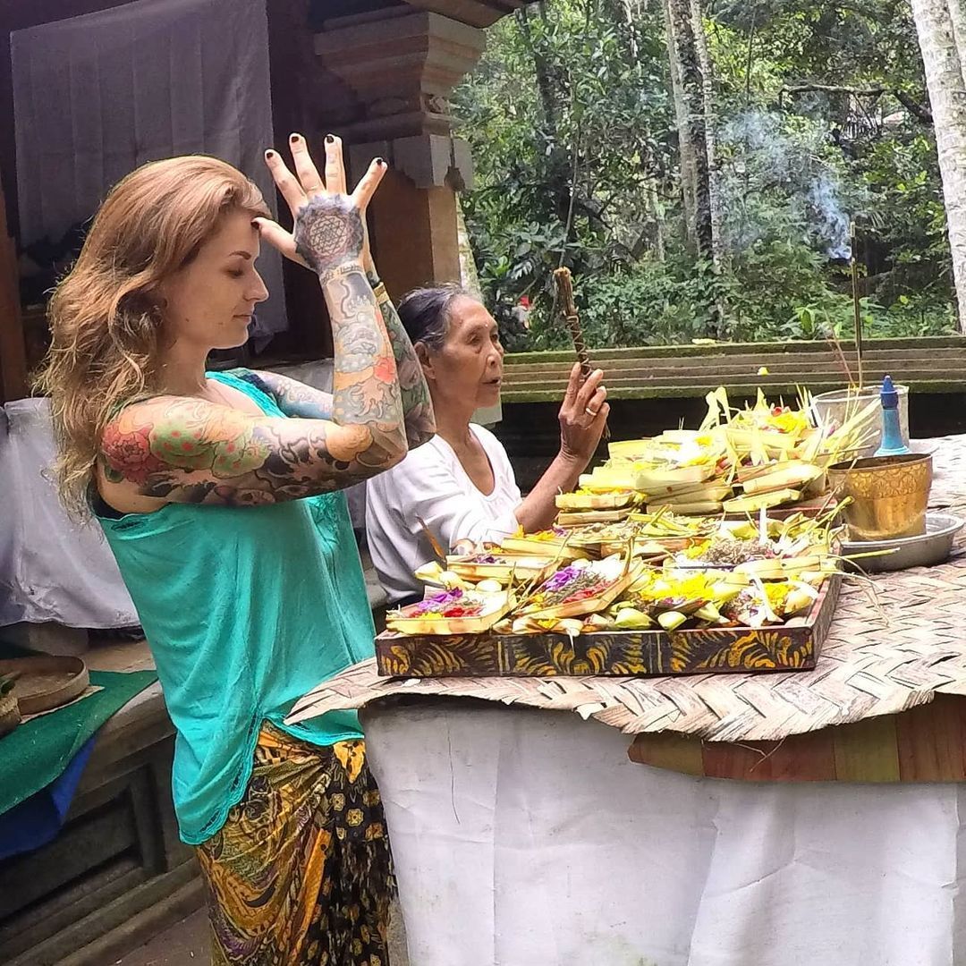 Me offering puja, or prayer, at a temple in Bali, Indonesia.