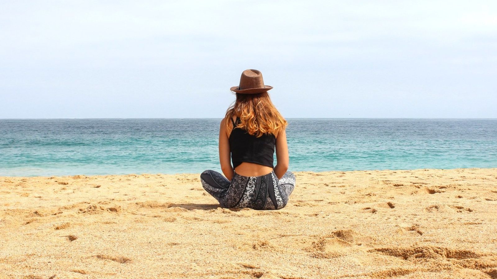 Woman practicing breathwork on beach