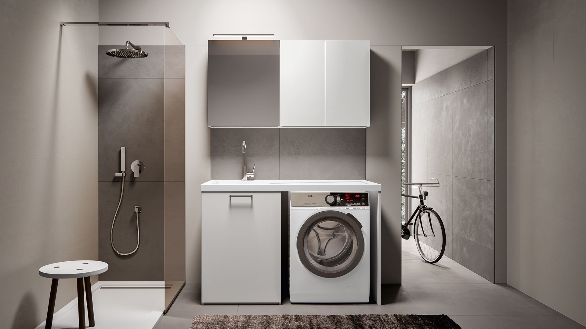 Un bagno minimalista con box doccia, mobiletto bianco con lavabo e lavatrice integrati e una bicicletta.