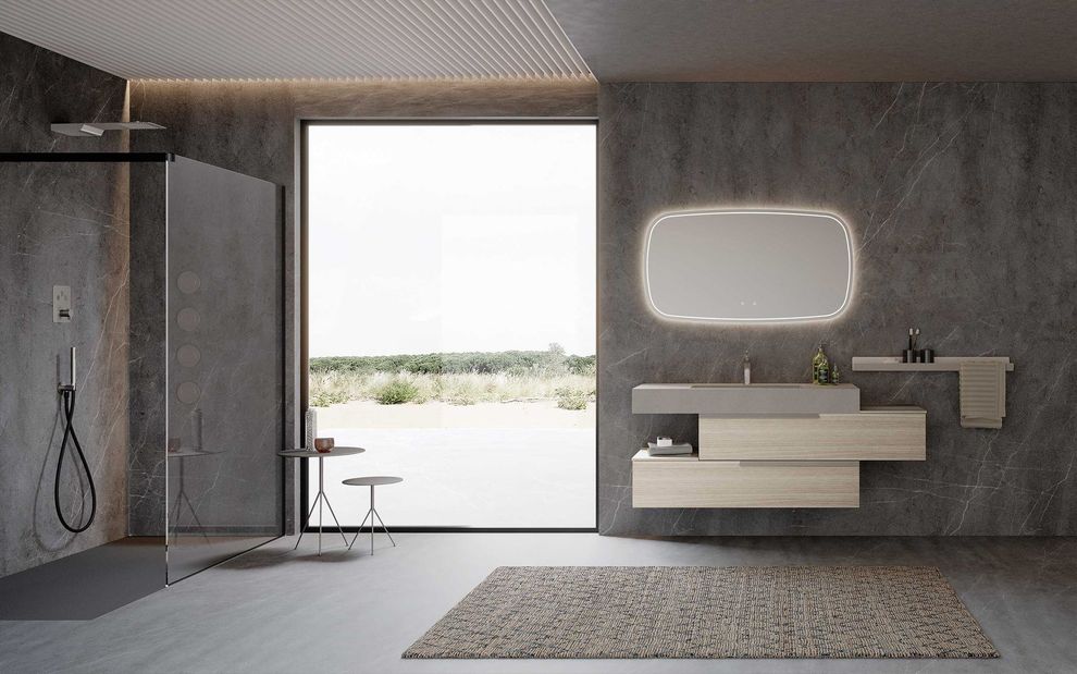 Arredo bagno moderno con lavabo, specchio e finiture ricercate.