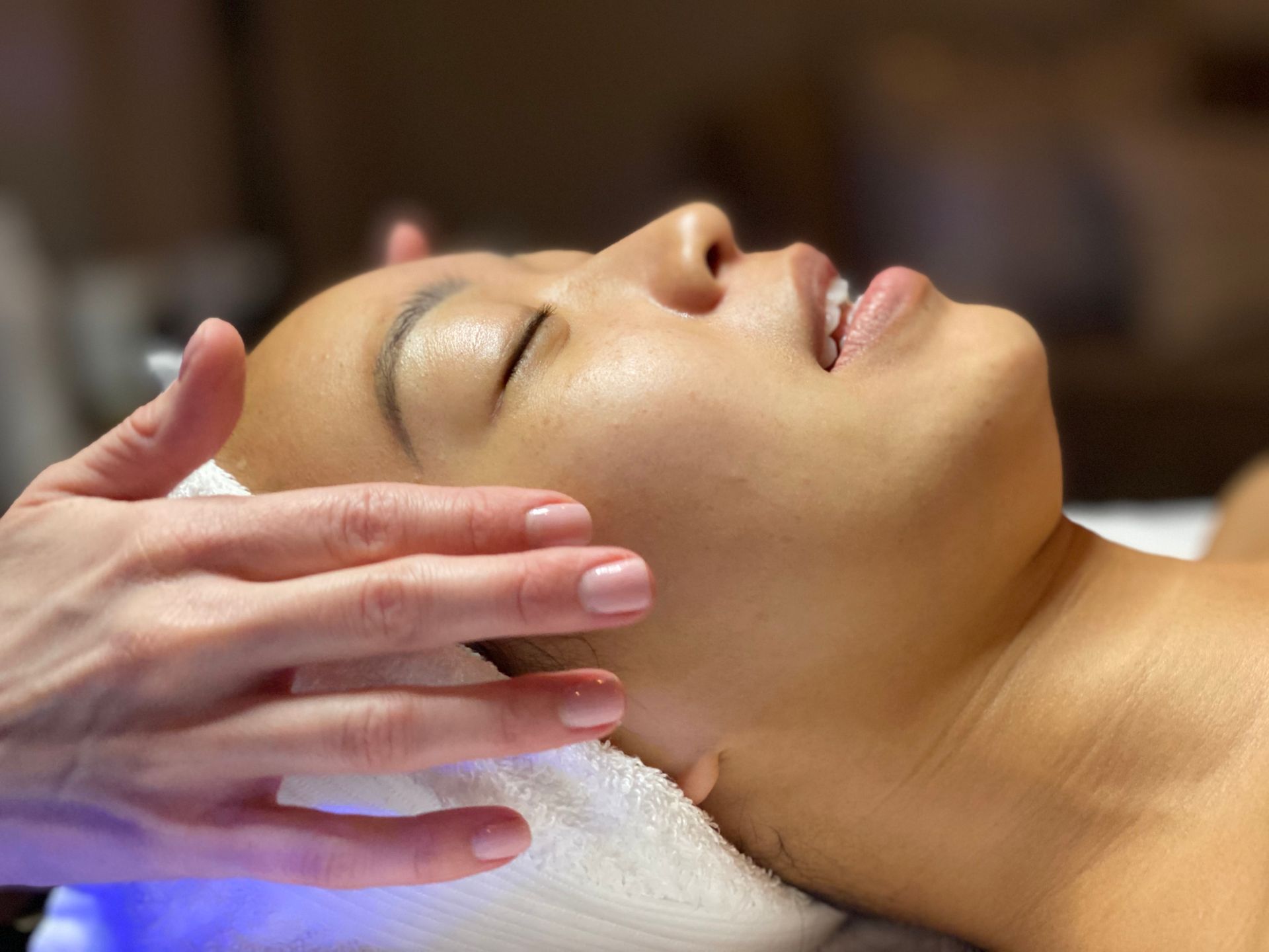 A woman is getting a massage on her face in a spa.