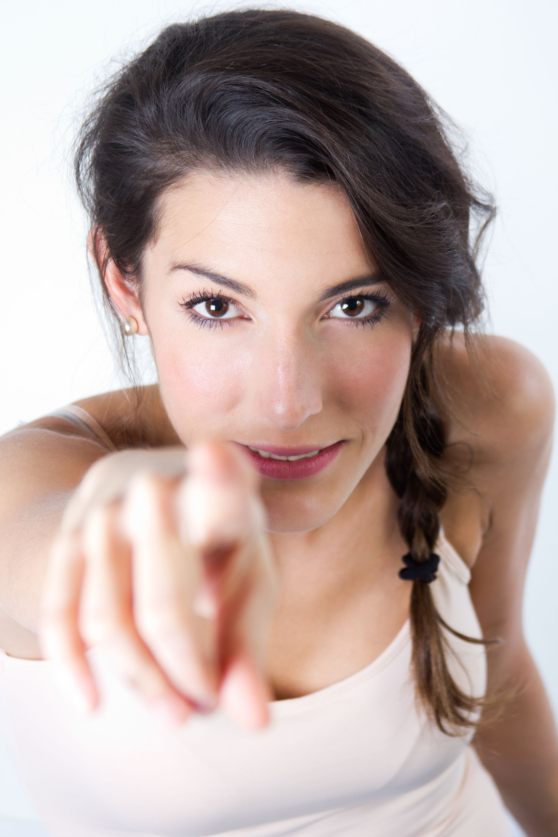 A woman is pointing at the camera with her finger.