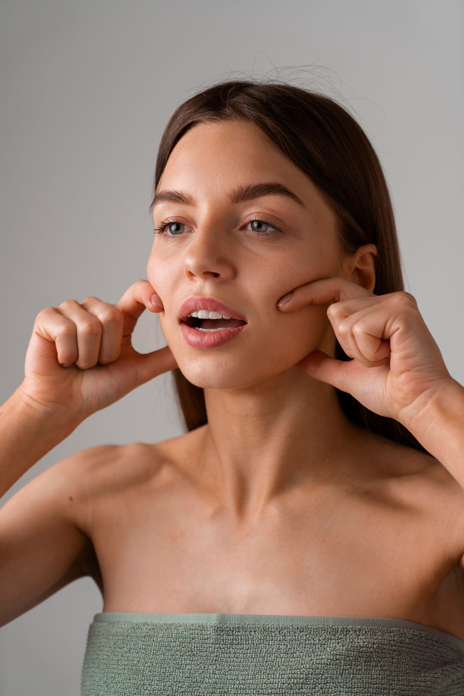 A woman touching her face with both hands