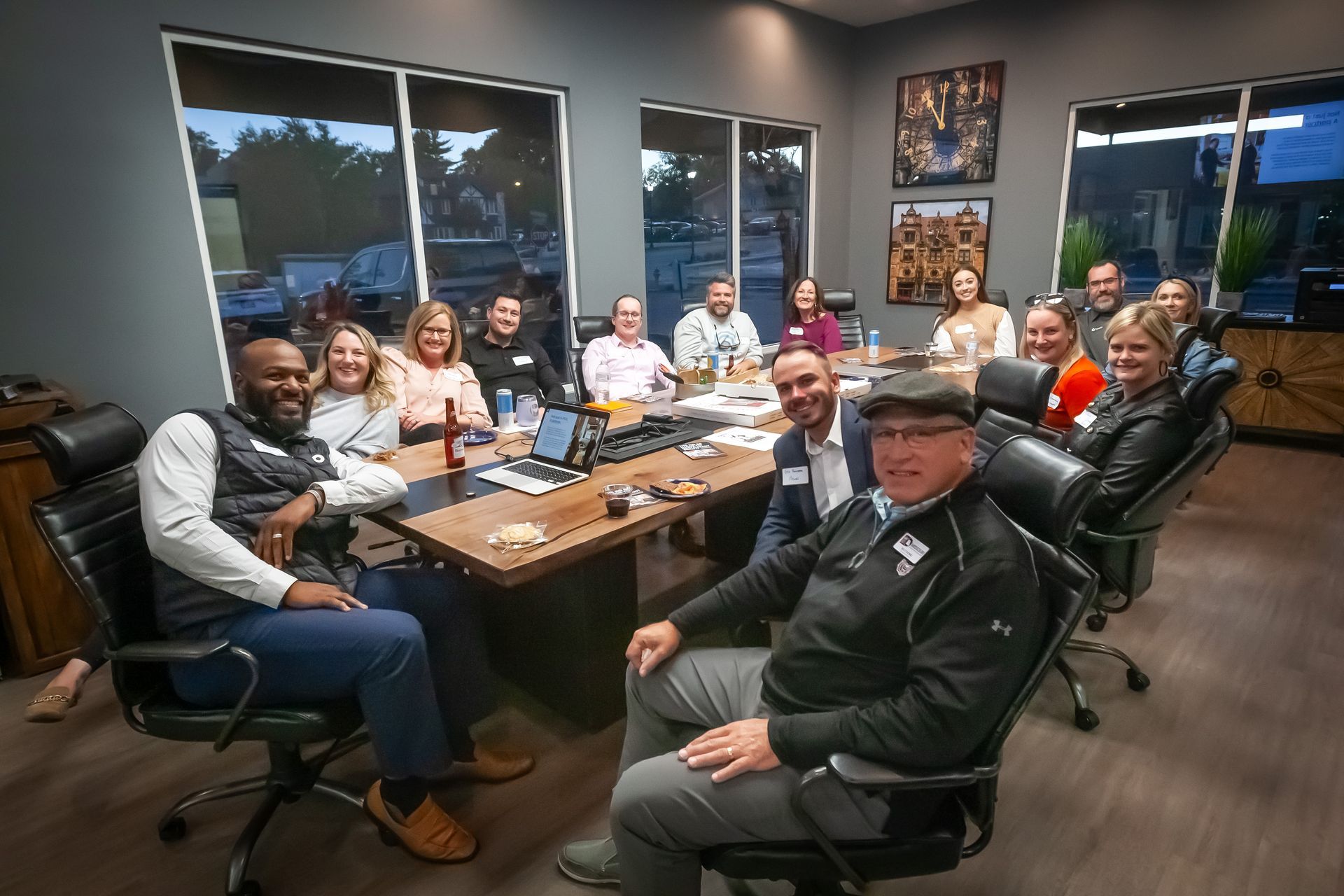 A group of people are sitting around a table in a conference room.