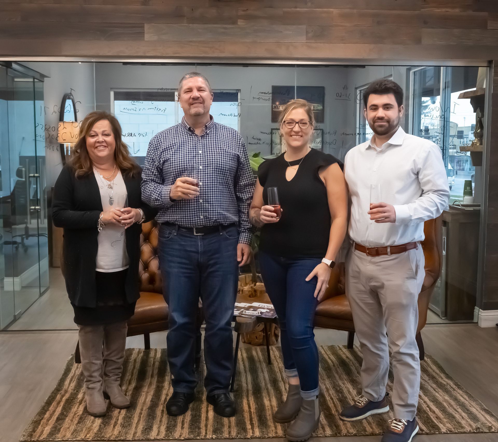 A group of people standing next to each other holding wine glasses