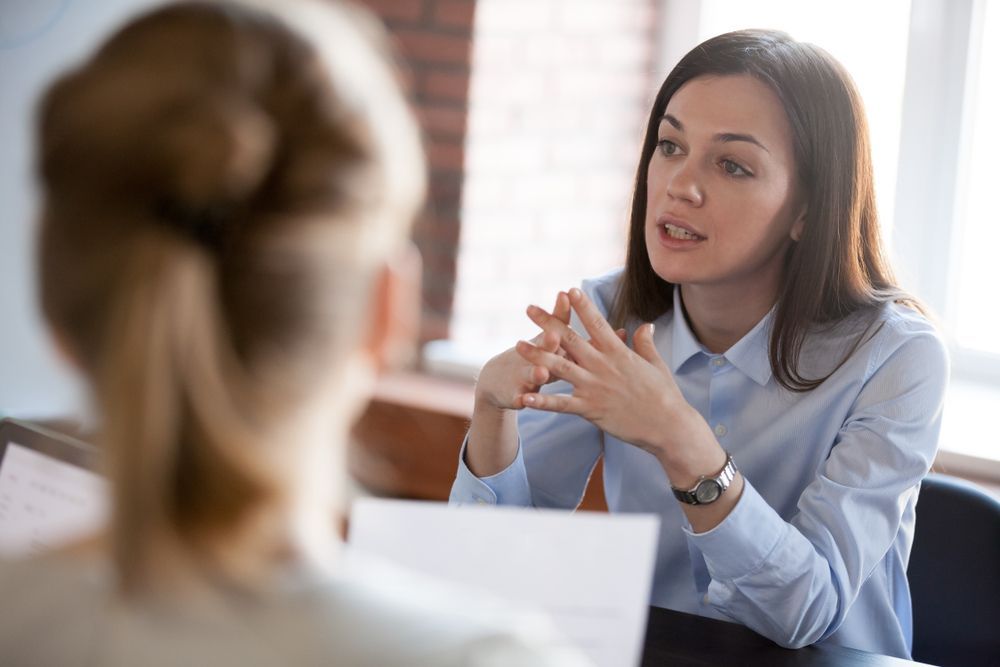Two Professionals Talk During a Meeting — Moreton Bay Therapy in Deception Bay, QLD
