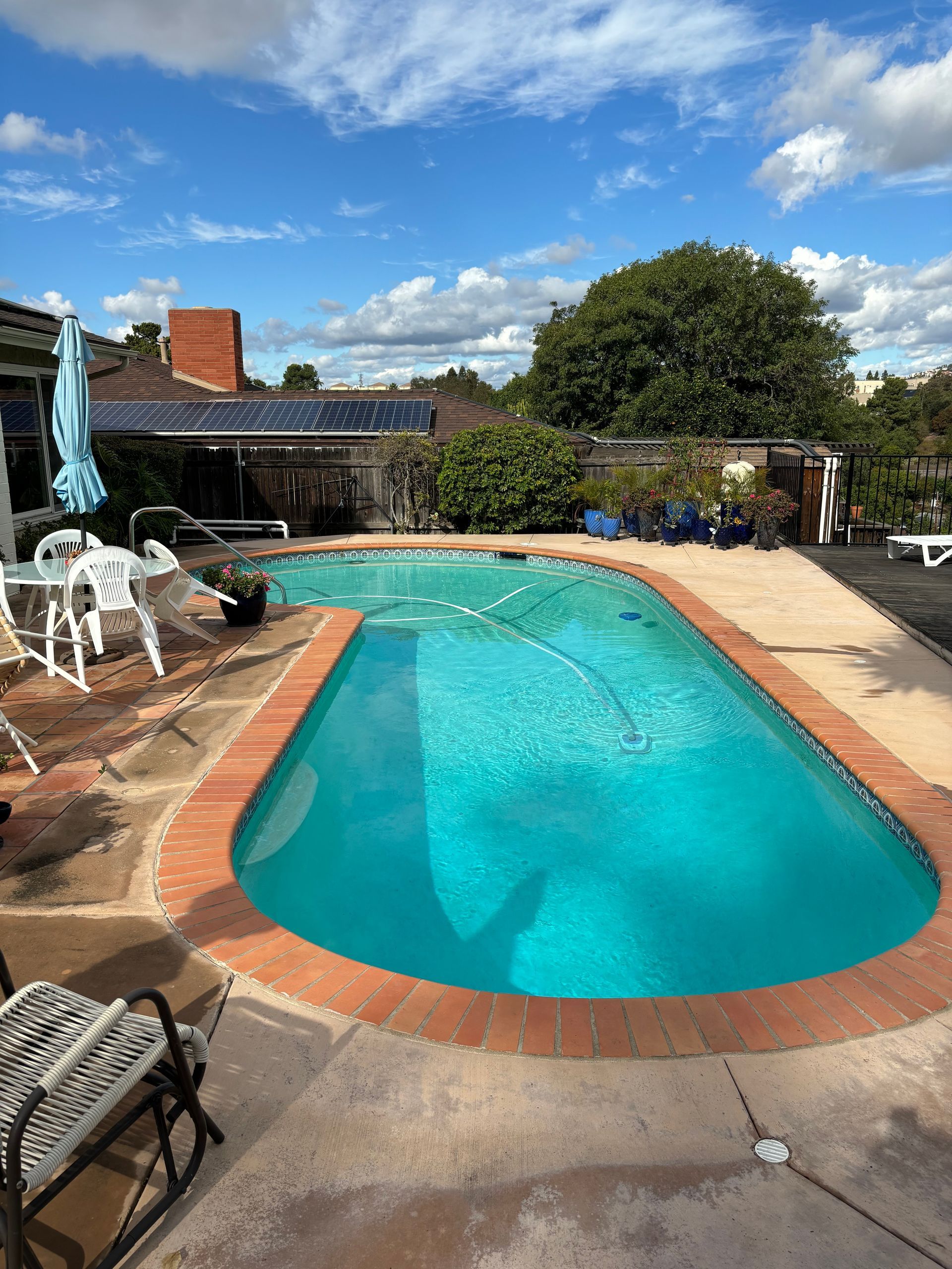 A large swimming pool surrounded by chairs and tables