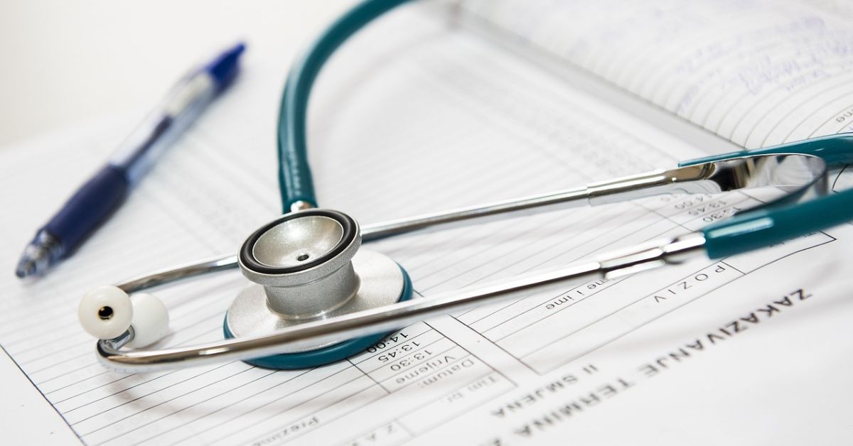 A stethoscope sitting on top of a Medicare appointment book.