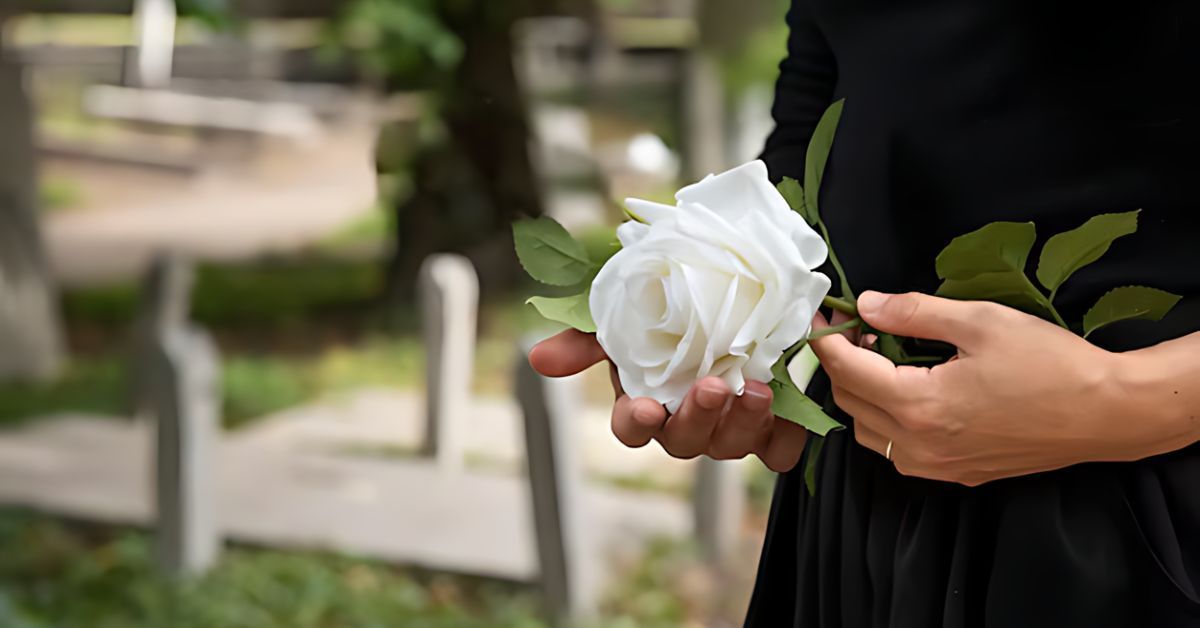 Funeral attendee holding a white rose.