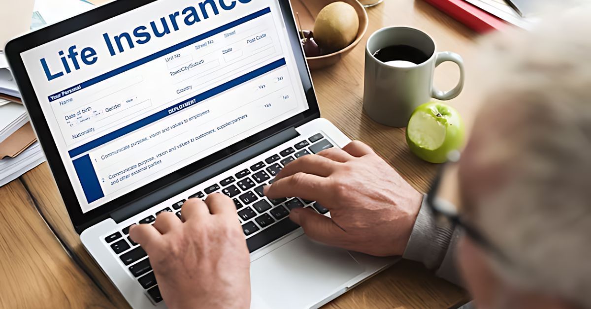 A man using a lap top to fill out a life insurance application.