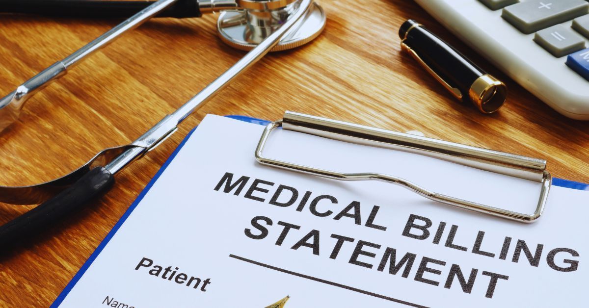 Medical billing statement on a clipboard sitting on a desk.