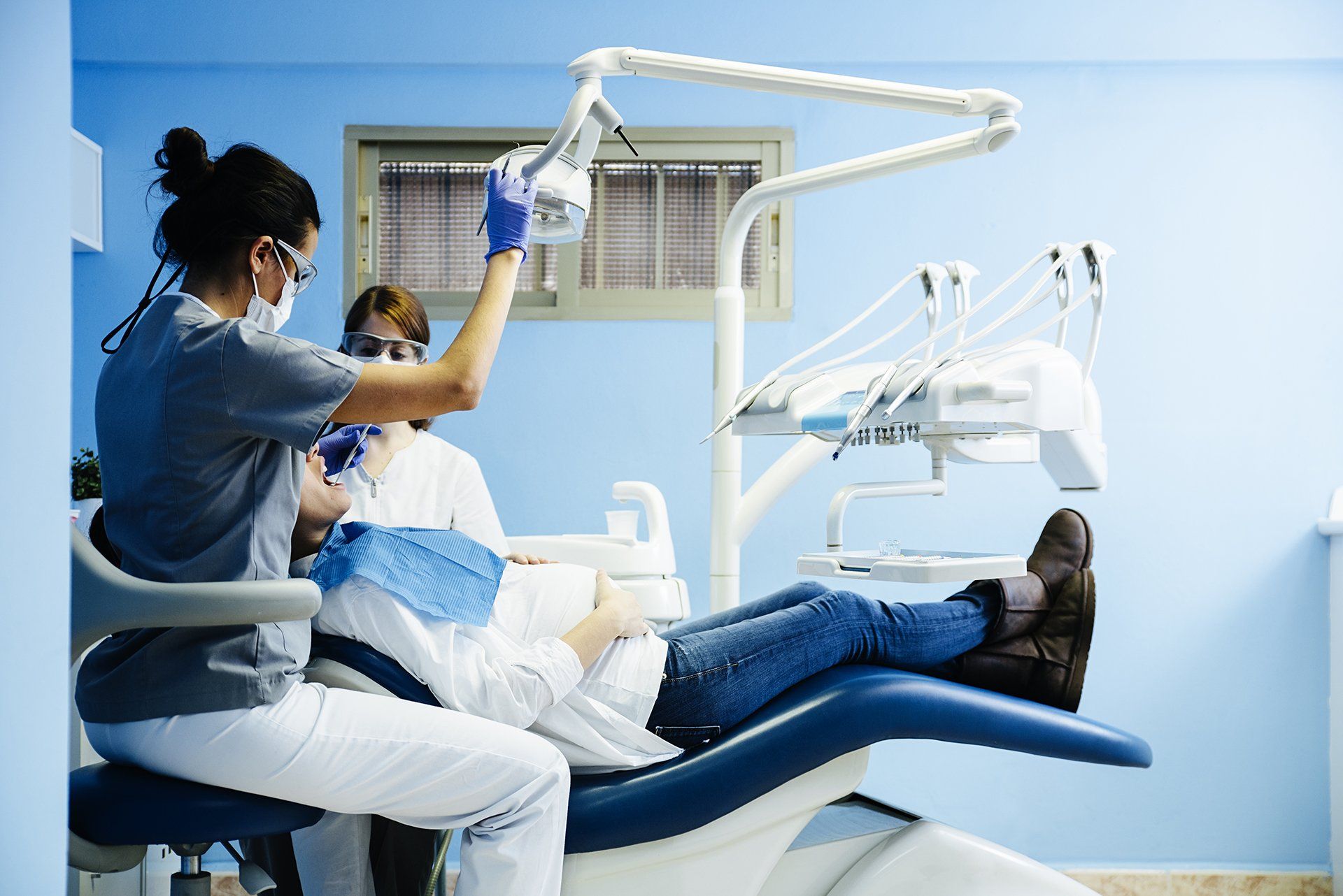Young man is getting treatment in dentist's office
