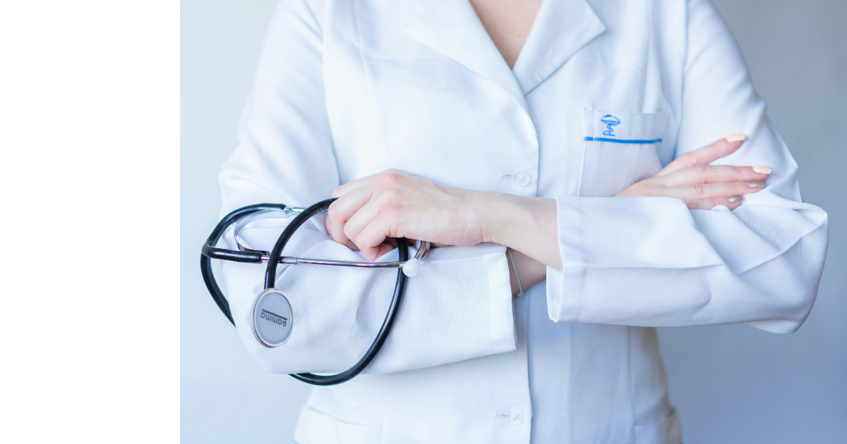 A black t-shirt with a skull on it is on a green background.