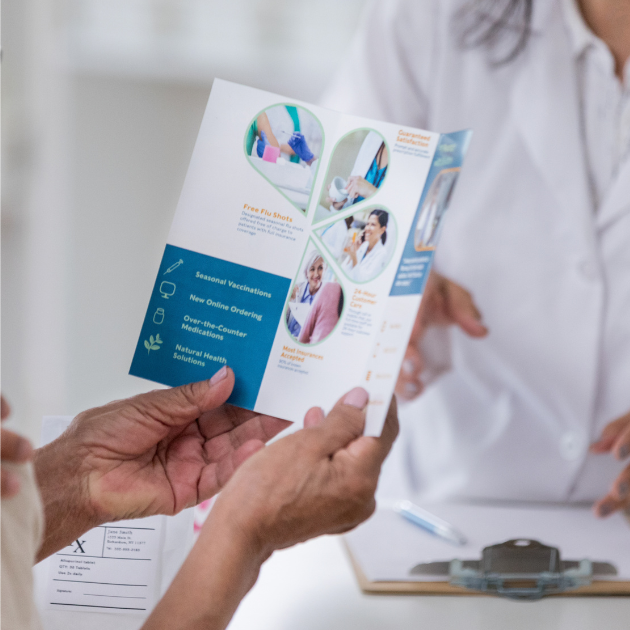A woman is wearing a black polo shirt with a white embroidered logo on the front.