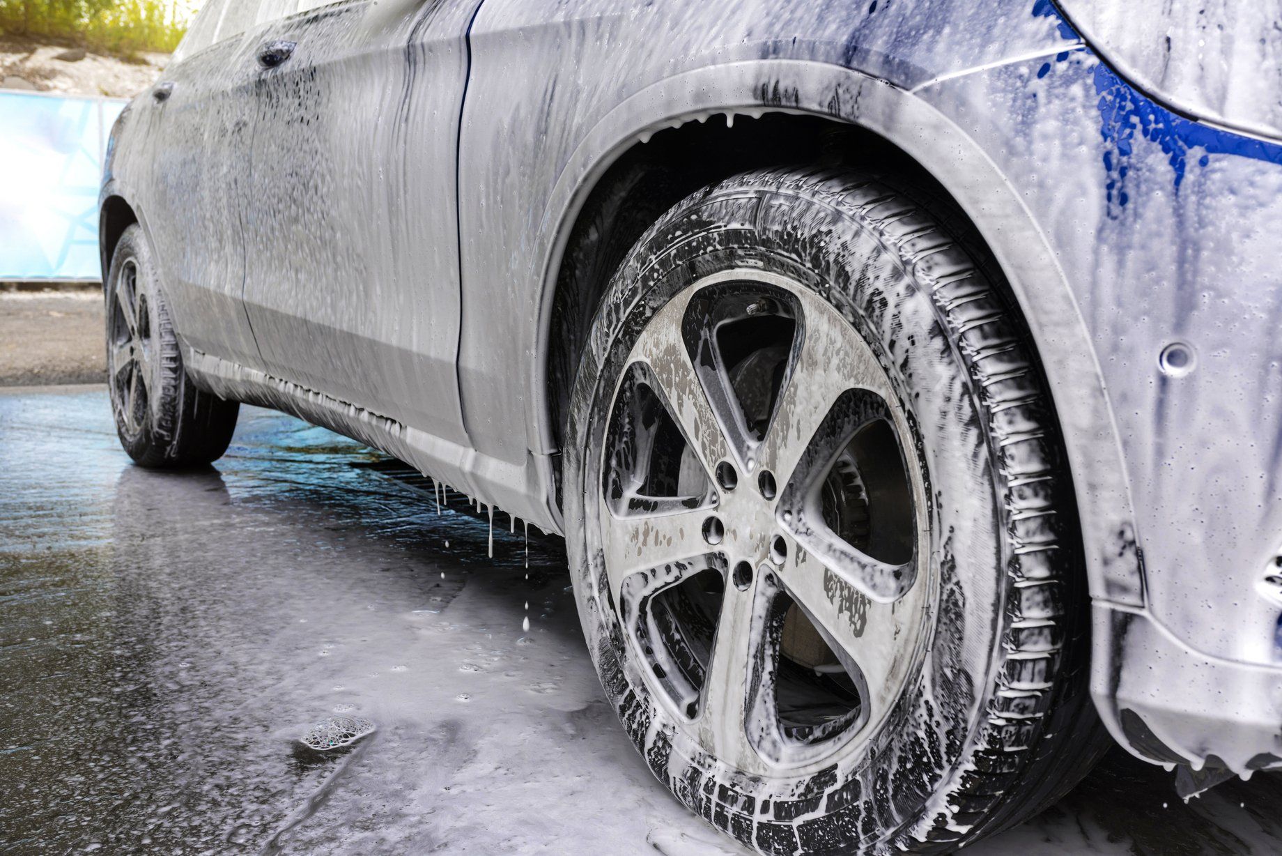 Sedan being washed lathered in suds