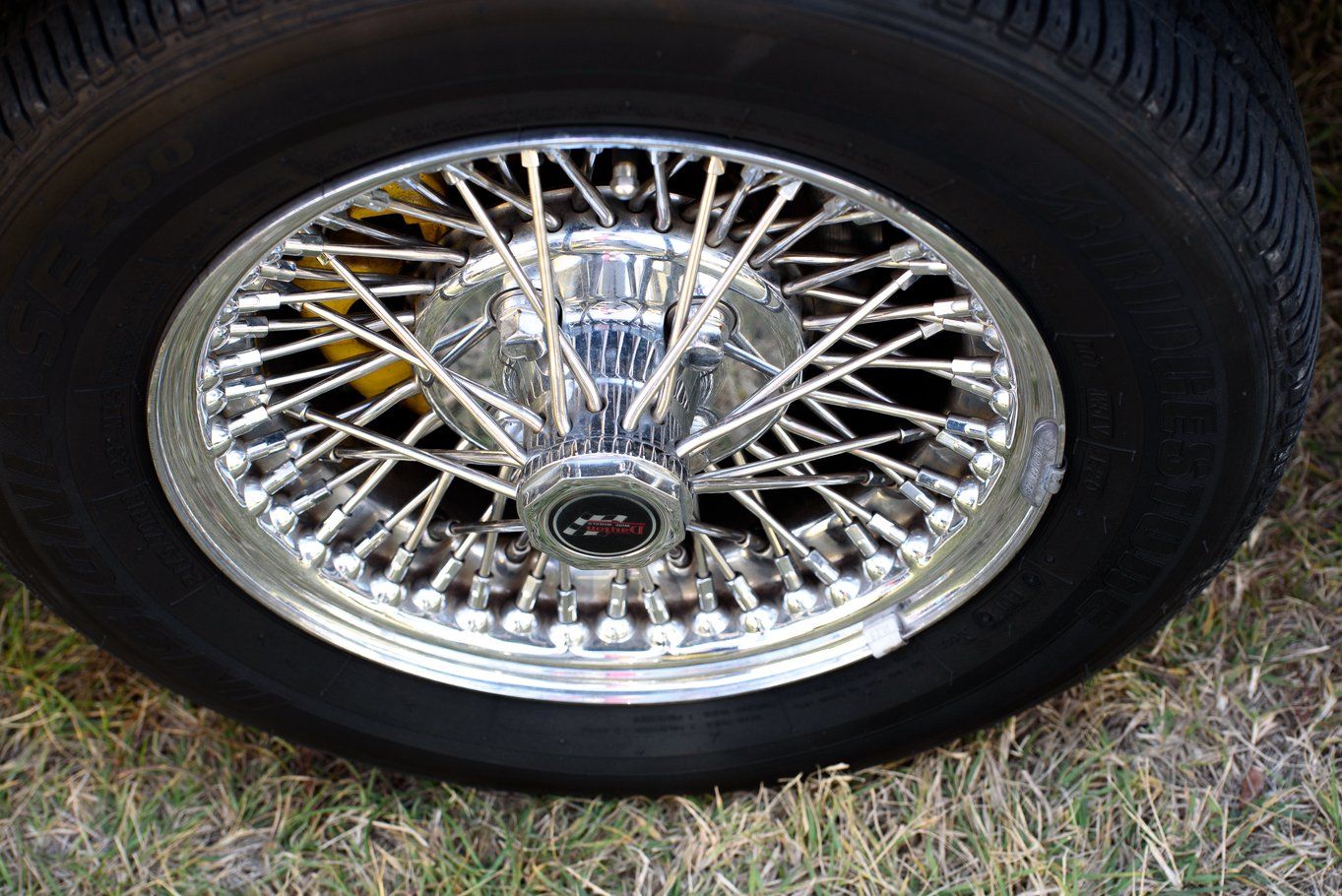 Two freshly polished roadster motorcycles parked beside the beach at sunset