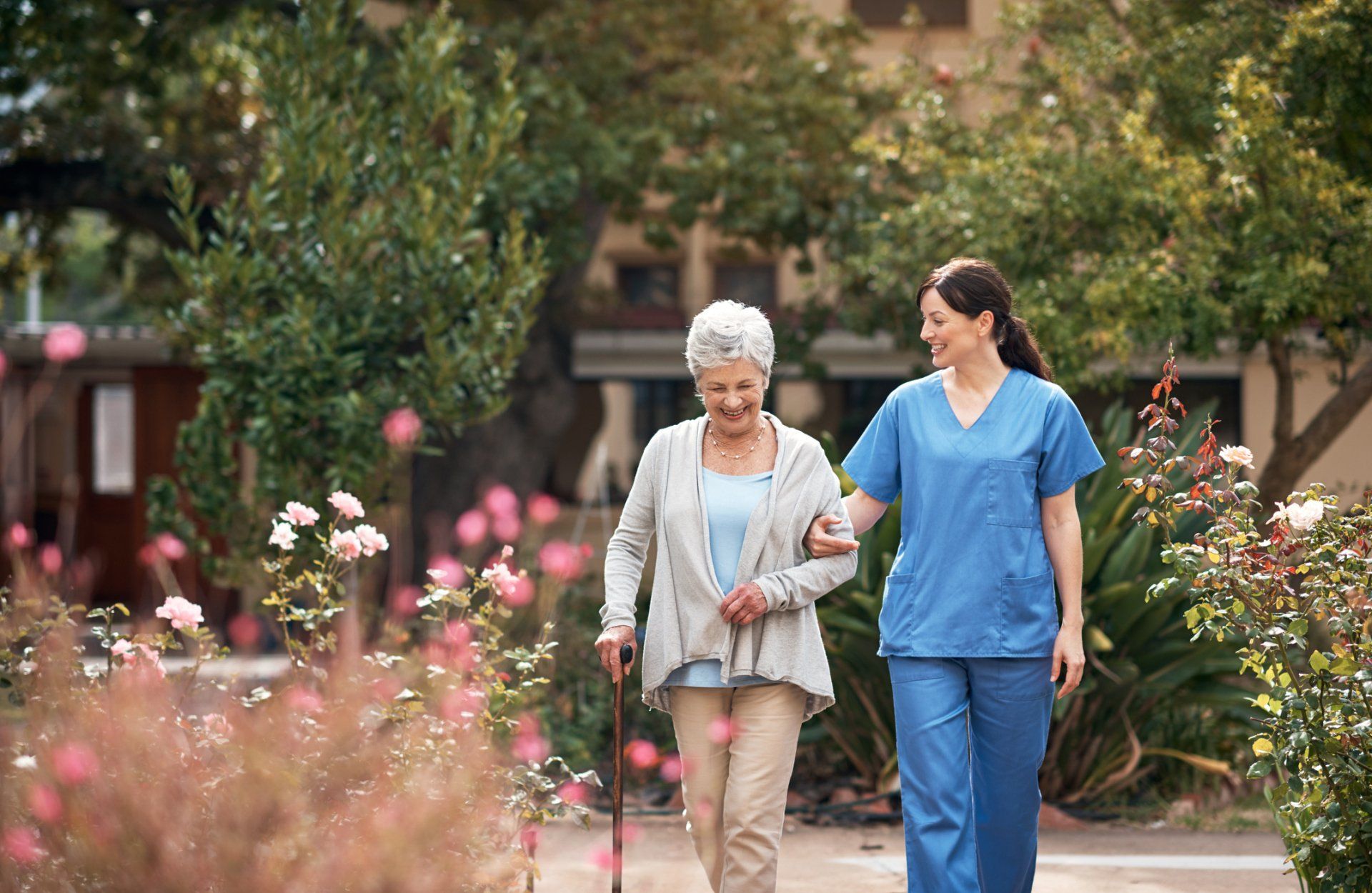 Caregiver and Her Patient out For a Walk in The Garden – Beaver Falls, PA – Cambridge Village