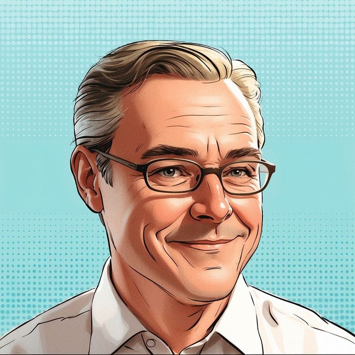 A man wearing glasses and a white shirt is smiling
