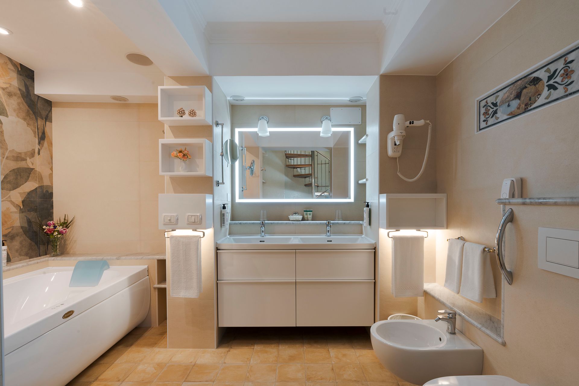 Modern bathroom with vanity mirror, bathtub, sink, toilet, and beige tile walls.