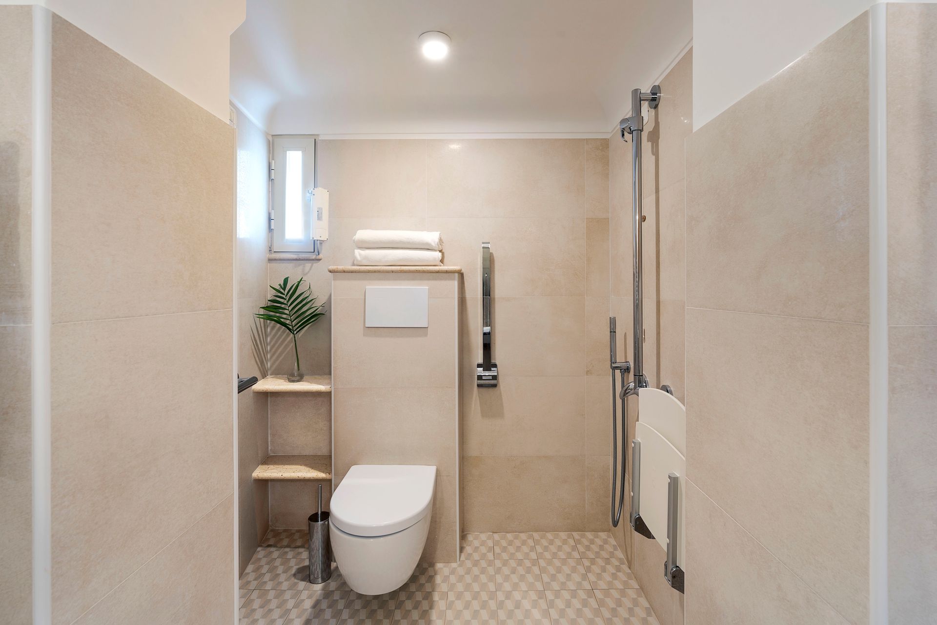 Modern beige bathroom with toilet, shower, and wood shelves