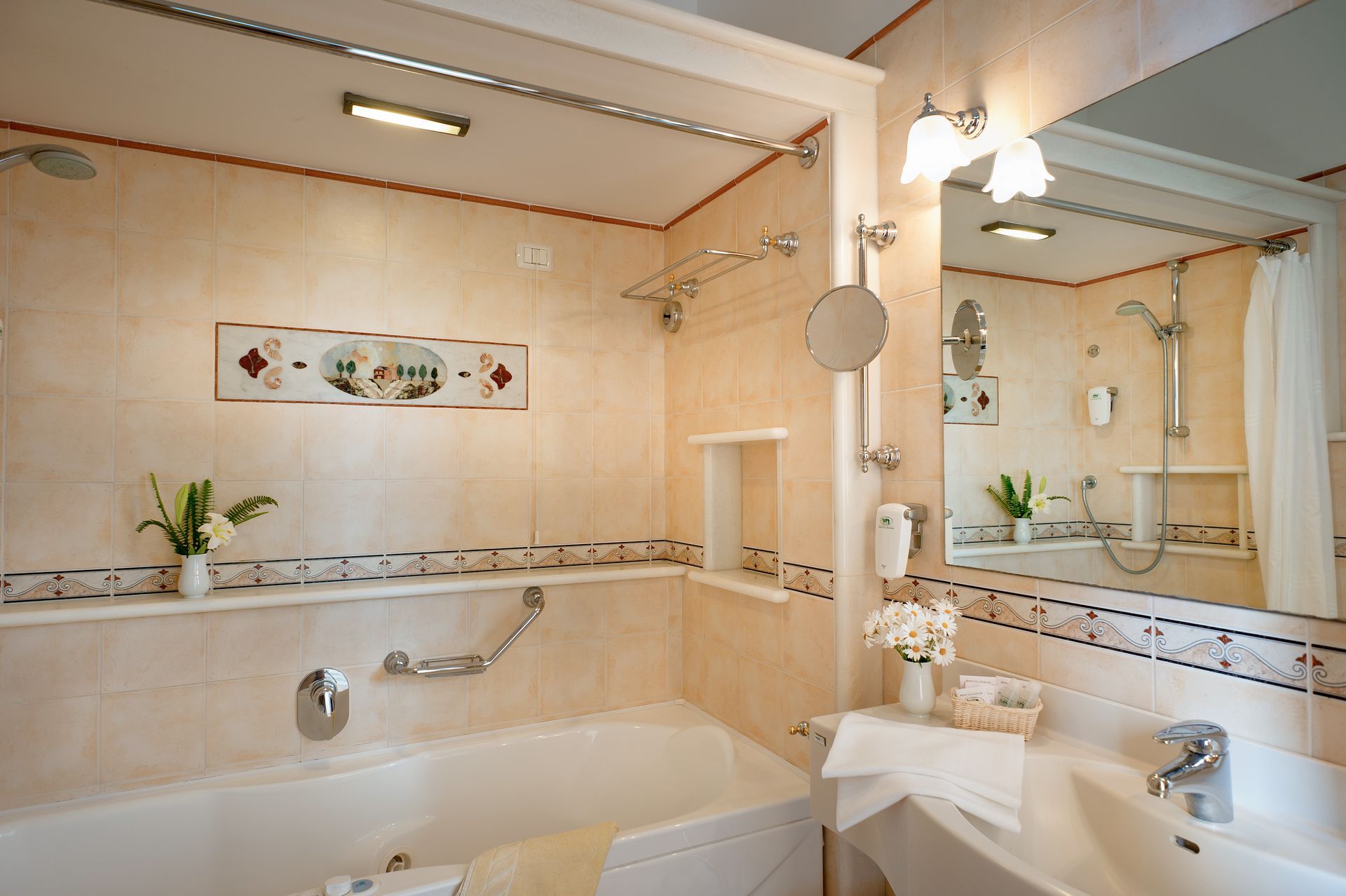 Bright beige bathroom with a bathtub, vanity sink, mirror, and wall decor