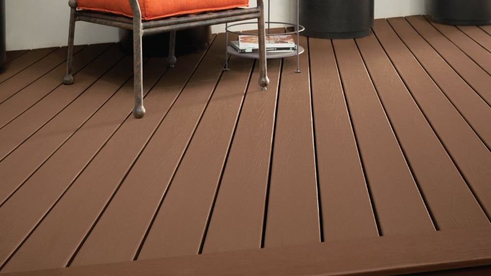 A wooden deck with a chair and a table on it.