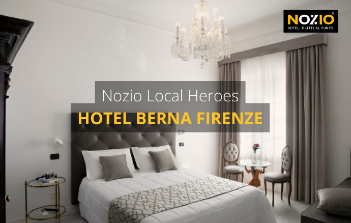 Camera d'albergo con letto, cuscini, lampadario, tende; Hotel Berna Firenze.