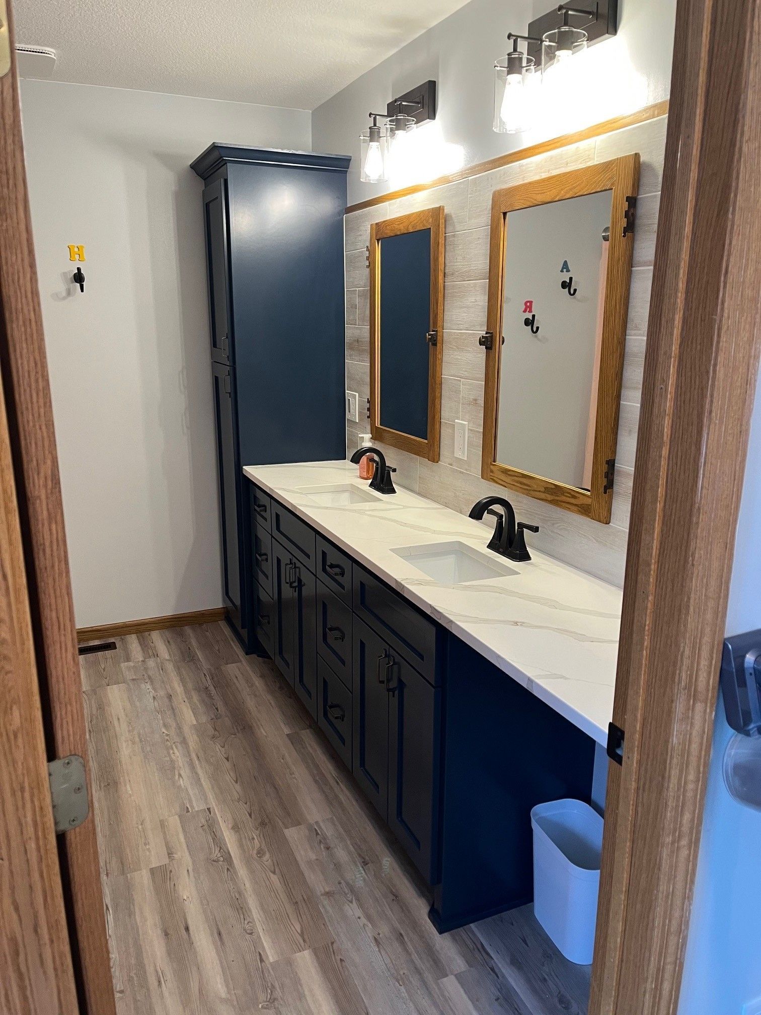 A bathroom with two sinks and two mirrors.