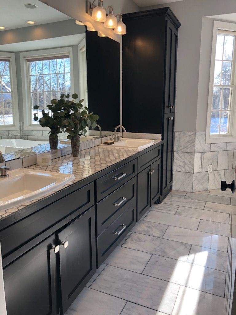 A bathroom with two sinks and a large mirror