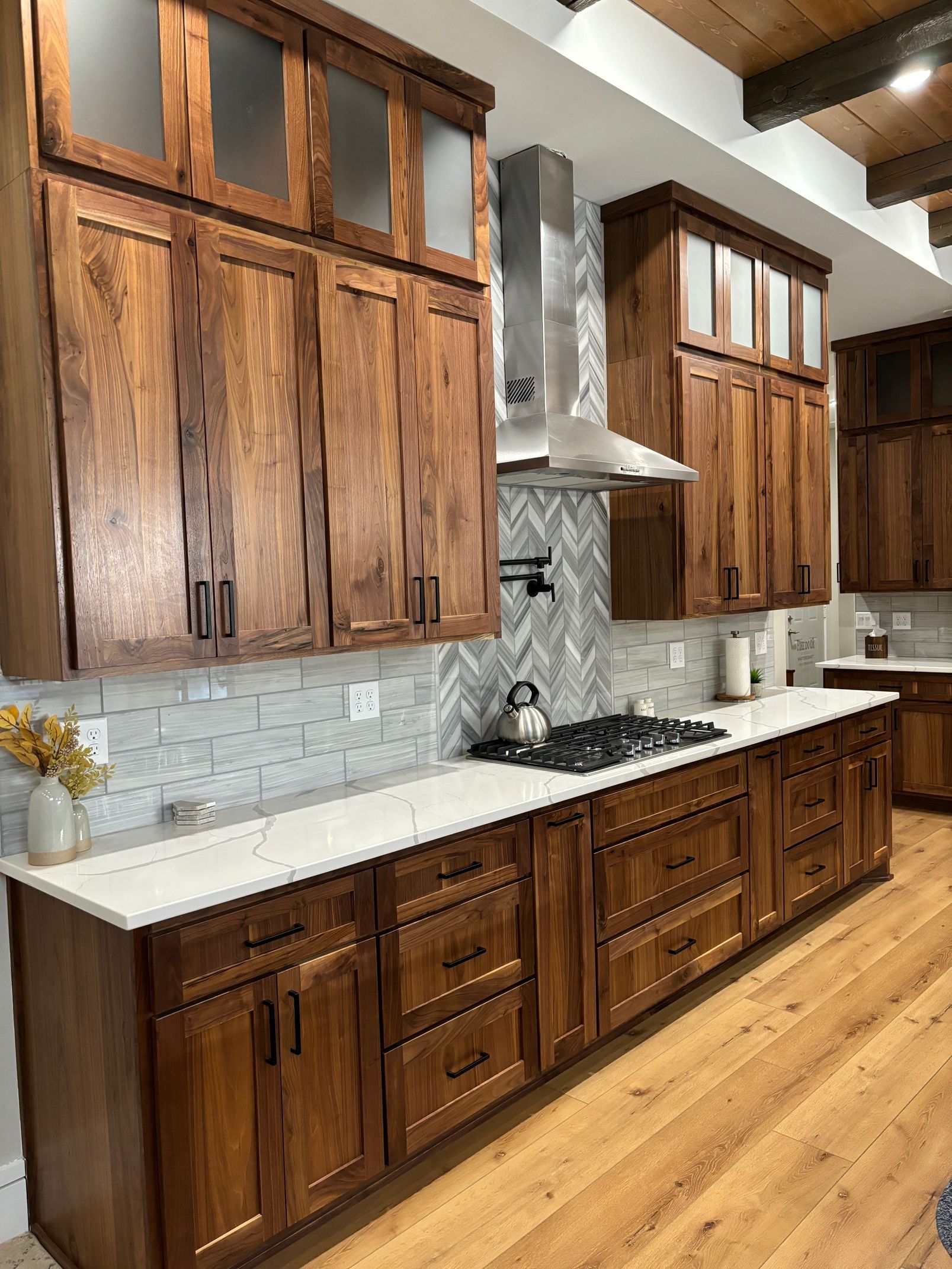A kitchen with wooden cabinets and a stove top oven.