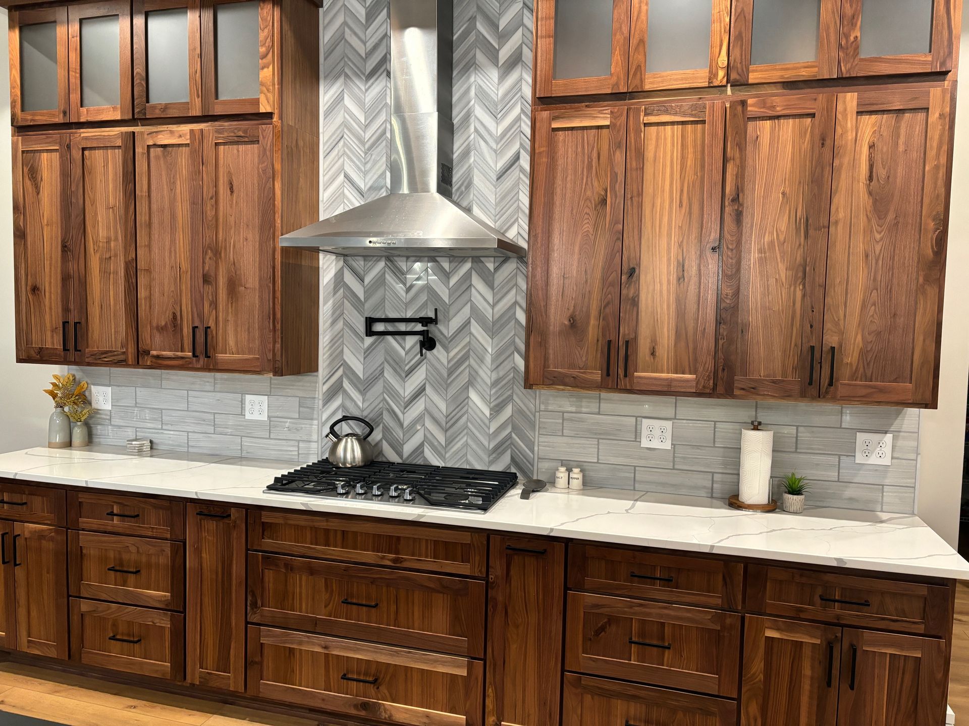 A kitchen with wooden cabinets and a stove top oven.