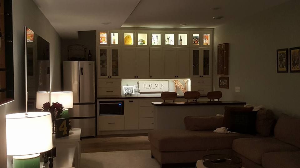 A living room with a couch and a kitchen in the background